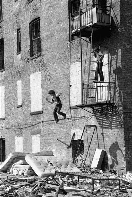 © Martha Cooper, Boy Jumping from Fire Escape, Lower East Side, 1978