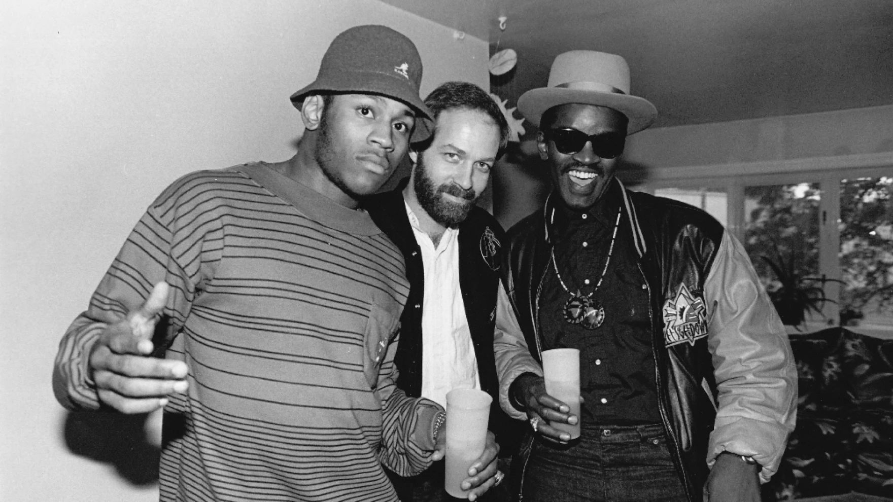 Bill Adler (center) with LL Cool J (left) and Fab 5 Freddy at LL's mother's house in 1988. | Photography by Daniel Root / Courtesy Of Bill Adler